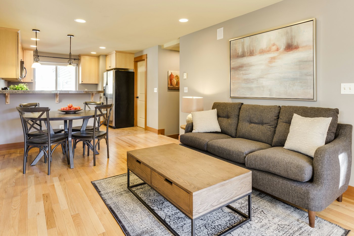 Tidy living room with wood floors and a gray sofa